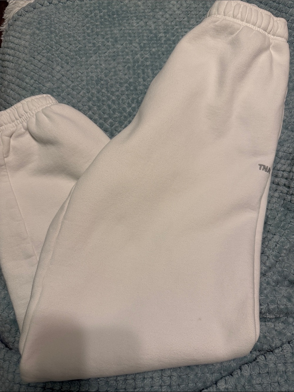 TNA Cozy Fleece Sweatpants in White with Teal Logo